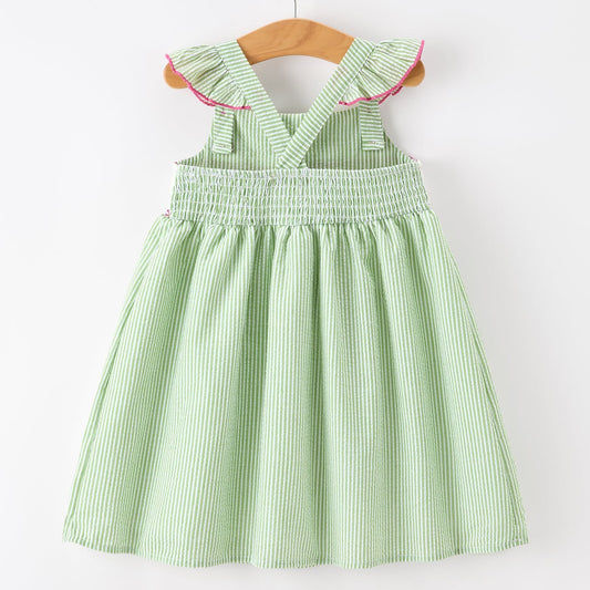 Green striped dress on a wooden hanger against a white background