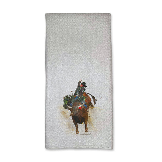 A vibrant western rodeo style kitchen hand towel featuring a bull rider on a bucking bull. Comes in a white color. The design captures the spirit of rodeo and western culture.