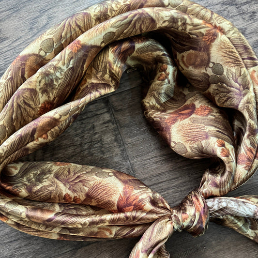 Close-up of 100% Silk Wild Rag Cactus with Neutral tones of beige tan, dark sage green, and light rust orange.