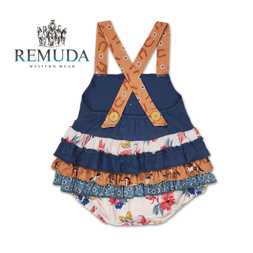 Back view of Western baby "Petals & Ponies" romper featuring a navy bodice, floral print, crossed back straps, ruffled side panels with running horses detail.