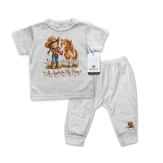 Children's gray short sleeve pajama outfit with shirt and pants featuring a cowgirl and horse design on a white background.