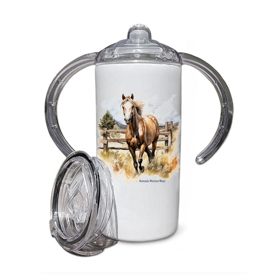 A children's sippy cup tumbler with a western theme, featuring a colorful image of a palomino horse running in a field with a wooden fence behind him.