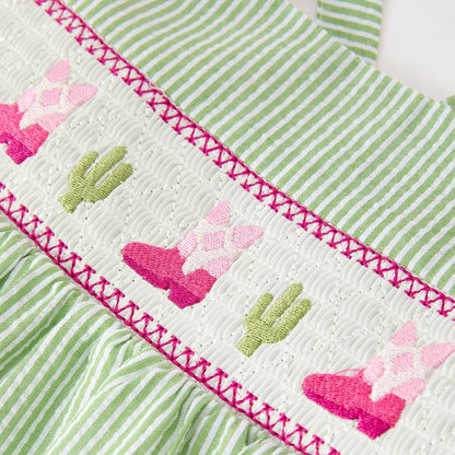 Green and white striped fabric with embroidered pink western boots and green cacti patterns.