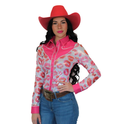 Woman wearing a pink and white floral western shirt with a red cowboy hat on a white background