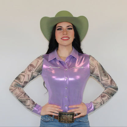 Woman in a cowboy hat and a purple rodeo shirt with money images on mesh sleeves on a white background.
