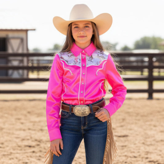 Person wearing a pink rodeo shirt, blue jeans, and a cowboy hat in an outdoor setting.