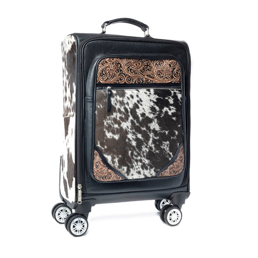 Black suitcase with hairon cowhide and tooled leather and decorative trim on a white background