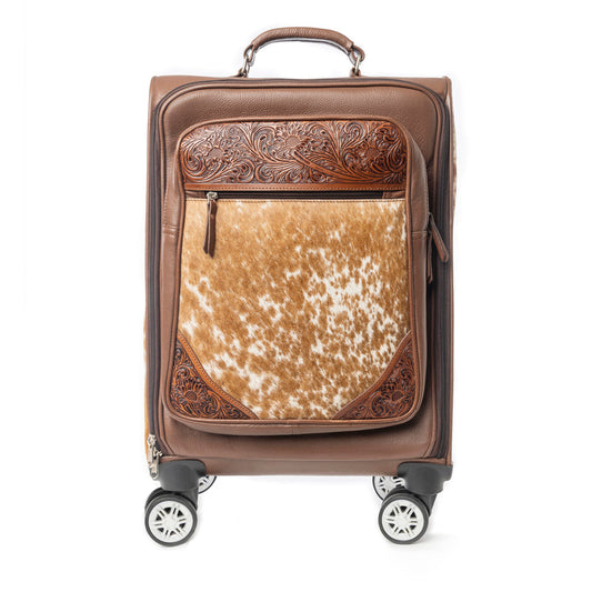 Brown carryon suitcase with hairon cowhide pattern and tooled leather on a white background