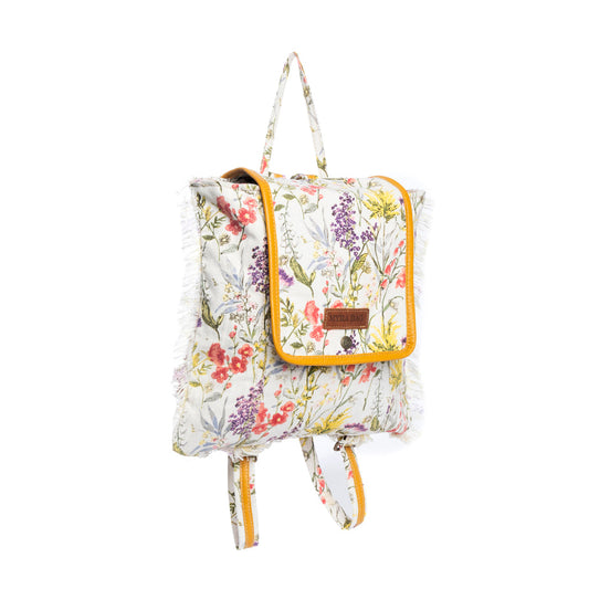 Floral-patterned backpack with leather accents on a white background