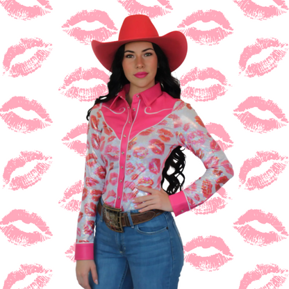 Woman wearing a pink and white patterned rodeo shirt with a red cowboy hat on a background with pink lipstick prints.