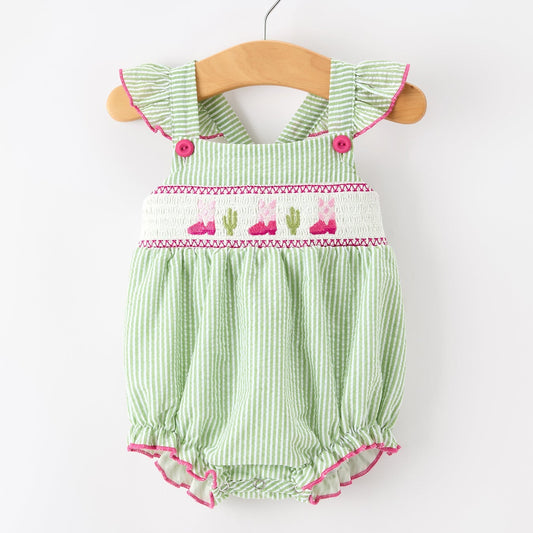 Green striped western boots and cactus baby romper with pink accents on a white background