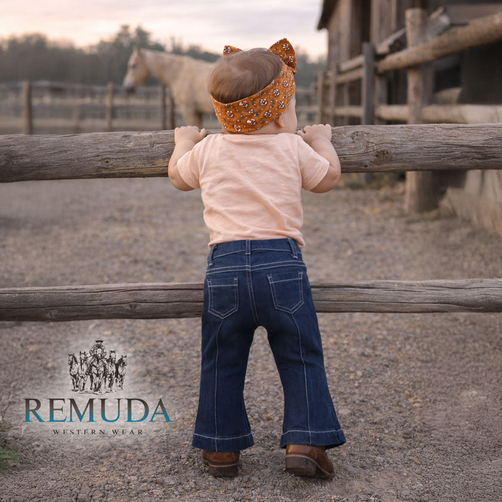 The back of Western baby girl flare denim jeans featuring a bell bottom fit, soft denim, and classic back pockets.