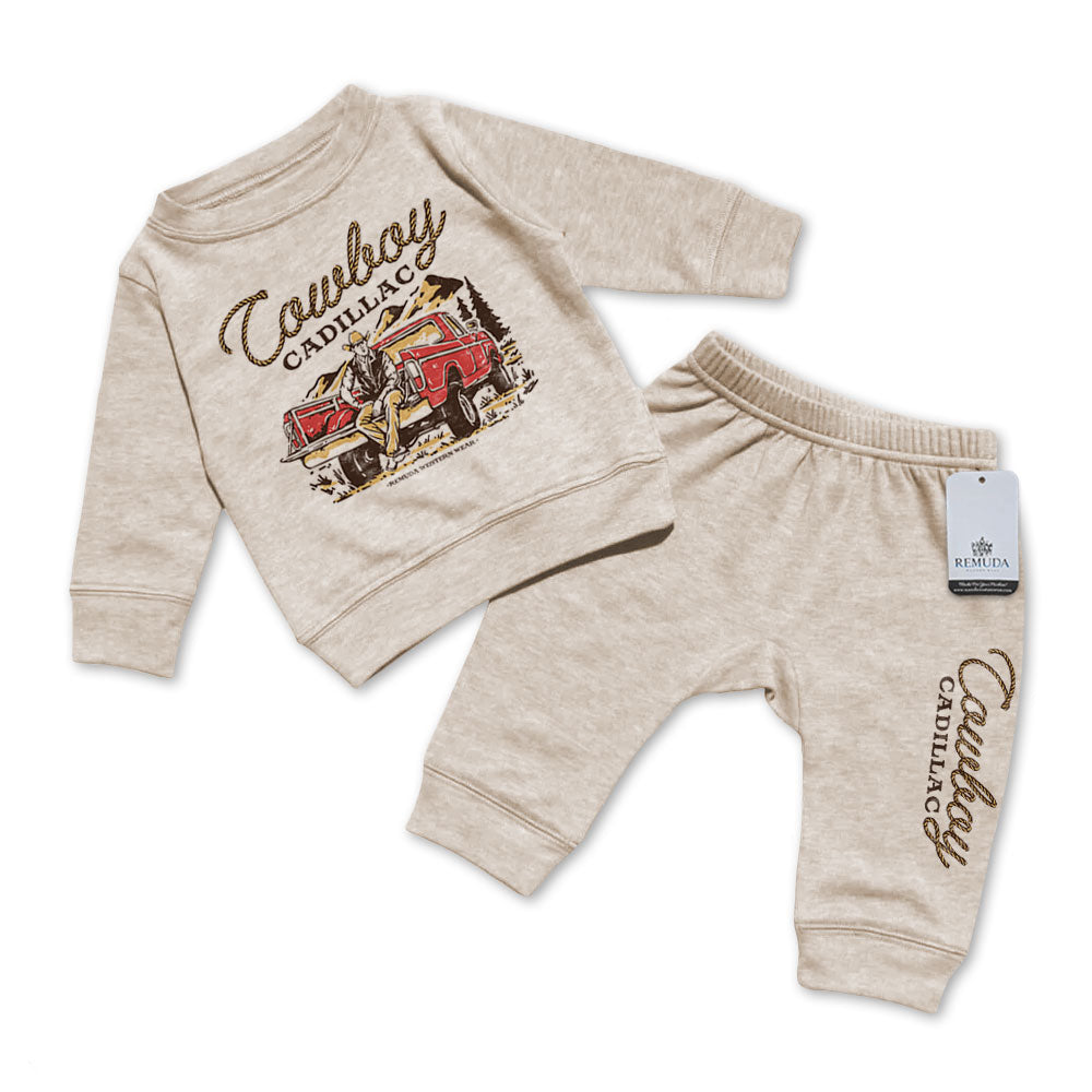 A custom two-piece infant sweatsuit featuring “Cowboy Cadillac” western graphic sweatshirt and matching jogger pants by Remuda Western Wear in Oatmeal color.