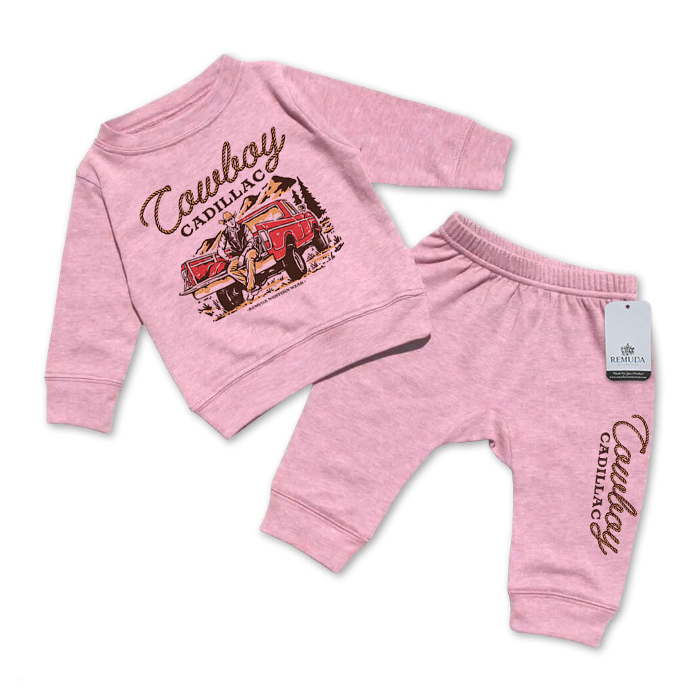 A custom two-piece infant sweatsuit featuring “Cowboy Cadillac” western graphic sweatshirt and matching jogger pants by Remuda Western Wear in Pink color.