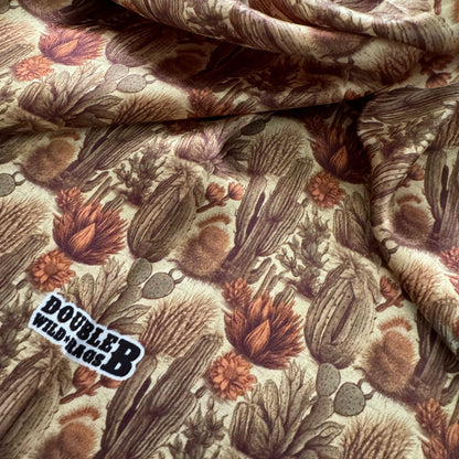 100% Silk Wild Rag Cactus with Neutral tones of beige tan, dark sage green, and light rust orange pattern