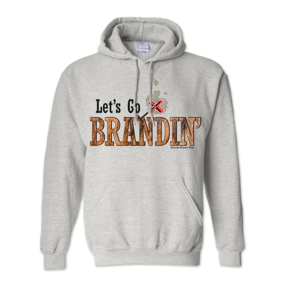 An adult vintage light ash gray colored hoodie with the phrase 'Let's Go Brandin'' printed in bold western letters across the chest. Above the text is an illustration of a classic western-style branding iron, emitting a faint glow of heat. The branding iron features a distinctive 'X' emblem, reminiscent of cattle branding. A great shirt for western wear, ranch wear, or rodeo wear.