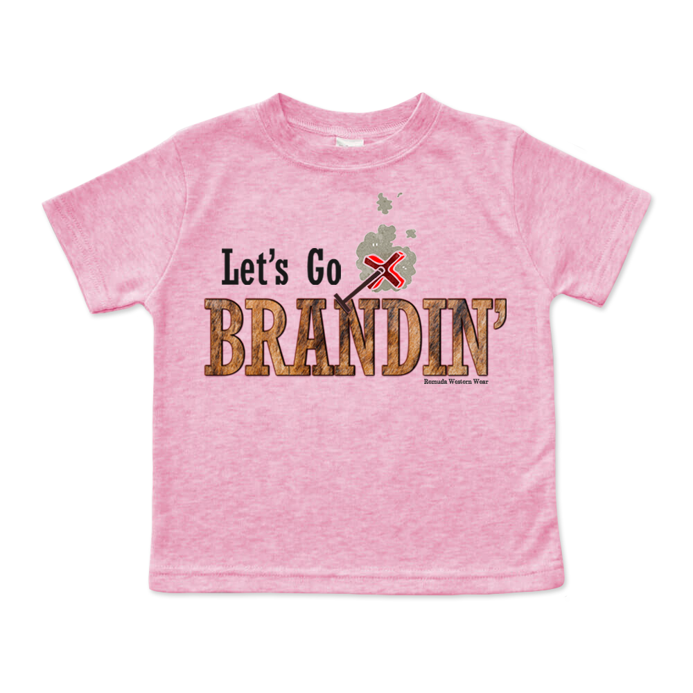 A stylish western-themed cotton candy pink colored infant t-shirt featuring the phrase 'Let's Go Brandin'' prominently printed in bold, weathered letters across the chest. Above the shirt is is an illustration of a branding iron, evoking a rustic cowboy aesthetic. Kids Western wear, Ranch wear and Rodeo wear.