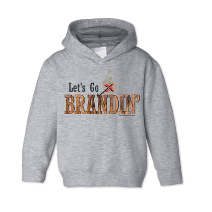 A vintage heather gray colored toddler hoodie with the phrase 'Let's Go Brandin'' printed in bold western letters across the chest. Above the text is an illustration of a classic western-style branding iron, emitting a faint glow of heat. The branding iron features a distinctive 'X' emblem, reminiscent of cattle branding. A great shirt for kids western wear, ranch wear, or rodeo wear.