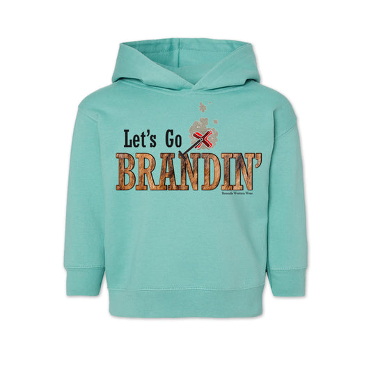 A vintage saltwater green colored toddler hoodie with the phrase 'Let's Go Brandin'' printed in bold western letters across the chest. Above the text is an illustration of a classic western-style branding iron, emitting a faint glow of heat. The branding iron features a distinctive 'X' emblem, reminiscent of cattle branding. A great shirt for kids western wear, ranch wear, or rodeo wear.