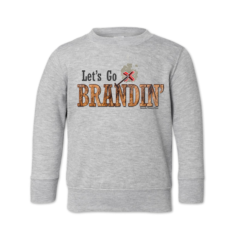 A toddler vintage heather gray colored sweatshirt with the phrase 'Let's Go Brandin'' printed in bold western letters across the chest. Above the text is an illustration of a classic western-style branding iron, emitting a faint glow of heat. The branding iron features a distinctive 'X' emblem, reminiscent of cattle branding. A great shirt for western wear, ranch wear, or rodeo wear.