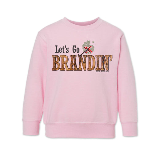 A toddler vintage light pink colored sweatshirt with the phrase 'Let's Go Brandin'' printed in bold western letters across the chest. Above the text is an illustration of a classic western-style branding iron, emitting a faint glow of heat. The branding iron features a distinctive 'X' emblem, reminiscent of cattle branding. A great shirt for western wear, ranch wear, or rodeo wear.