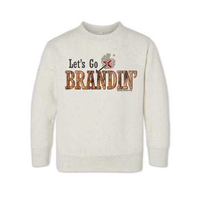 A toddler vintage oatmeal colored sweatshirt with the phrase 'Let's Go Brandin'' printed in bold western letters across the chest. Above the text is an illustration of a classic western-style branding iron, emitting a faint glow of heat. The branding iron features a distinctive 'X' emblem, reminiscent of cattle branding. A great shirt for western wear, ranch wear, or rodeo wear.