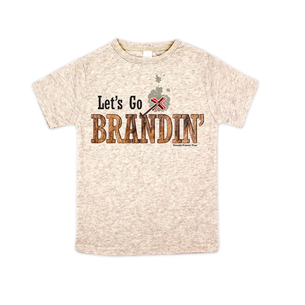 A stylish western-themed oatmeal colored toddler t-shirt featuring the phrase 'Let's Go Brandin'' prominently printed in bold, weathered letters across the chest. Above the shirt is is an illustration of a branding iron, evoking a rustic cowboy aesthetic. Kids Western wear, Ranch wear and Rodeo wear.