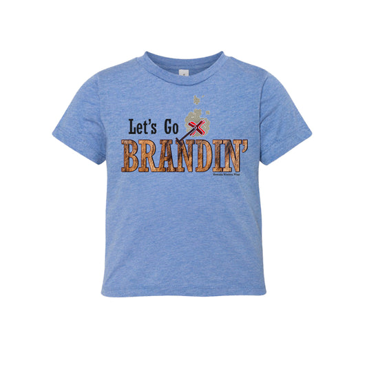 A stylish western-themed blue colored toddler t-shirt featuring the phrase 'Let's Go Brandin'' prominently printed in bold, weathered letters across the chest. Above the shirt is is an illustration of a branding iron, evoking a rustic cowboy aesthetic. Kids Western wear, Ranch wear and Rodeo wear.