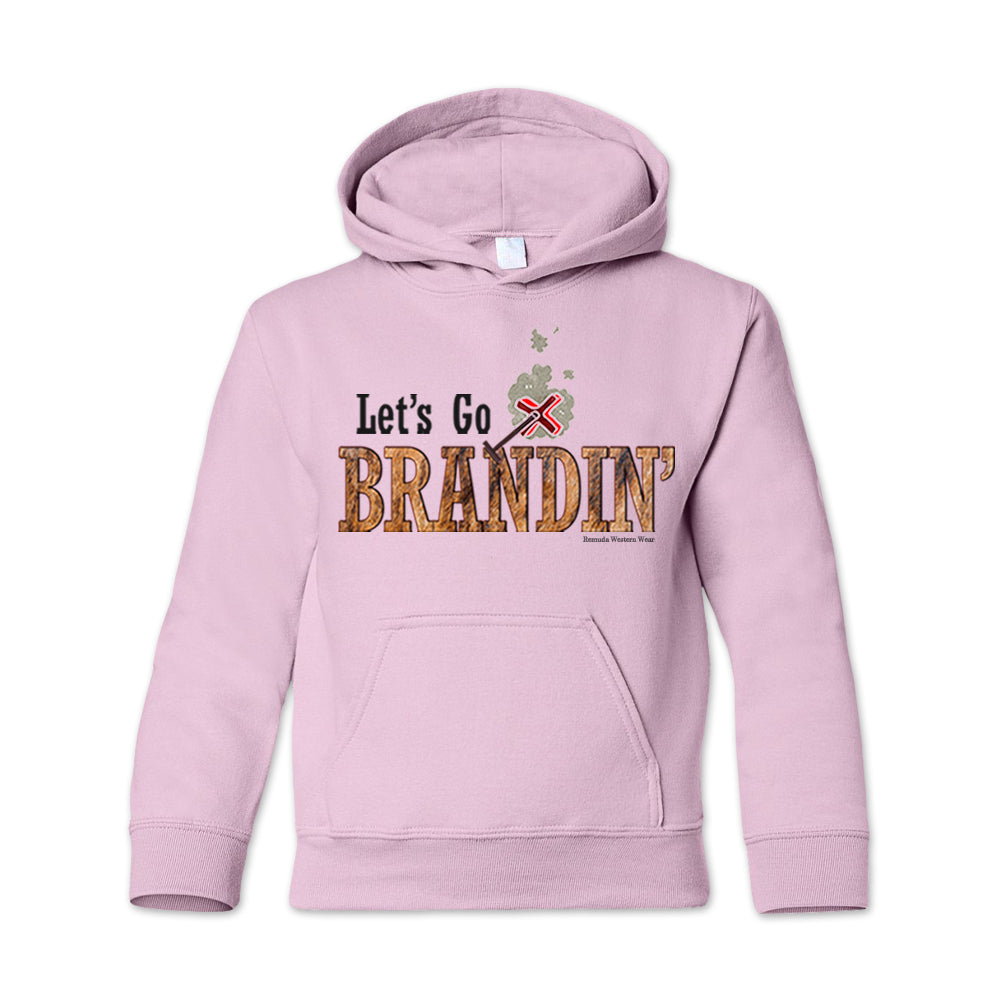 A vintage light pink colored youth hoodie with the phrase 'Let's Go Brandin'' printed in bold western letters across the chest. Above the text is an illustration of a classic western-style branding iron, emitting a faint glow of heat. The branding iron features a distinctive 'X' emblem, reminiscent of cattle branding. A great shirt for western wear, ranch wear, or rodeo wear.