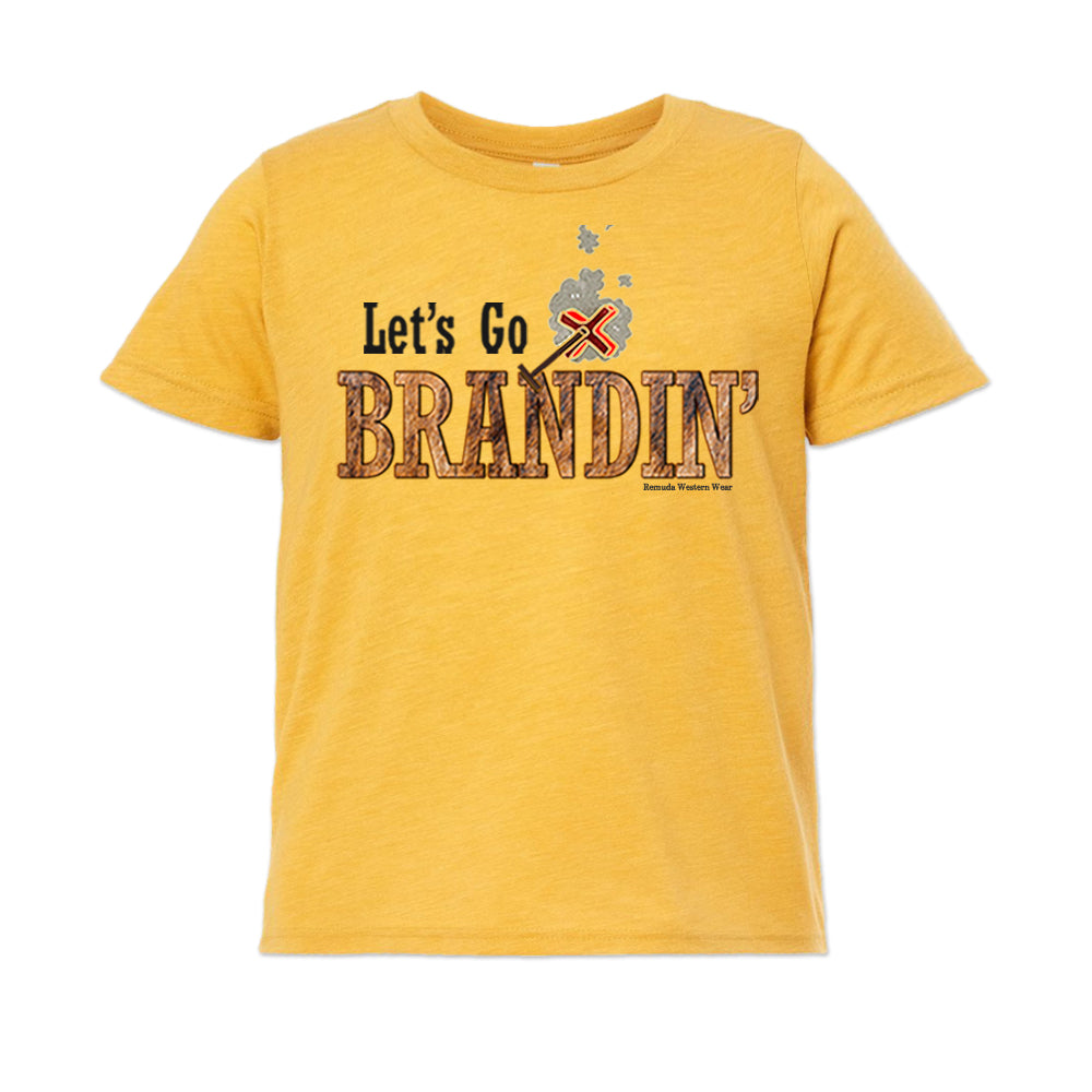 A stylish western-themed mustard yellow colored youth t-shirt featuring the phrase 'Let's Go Brandin'' prominently printed in bold, weathered letters across the chest. Above the shirt is is an illustration of a branding iron, evoking a rustic cowboy aesthetic. Kids Western wear, Ranch wear and Rodeo wear.