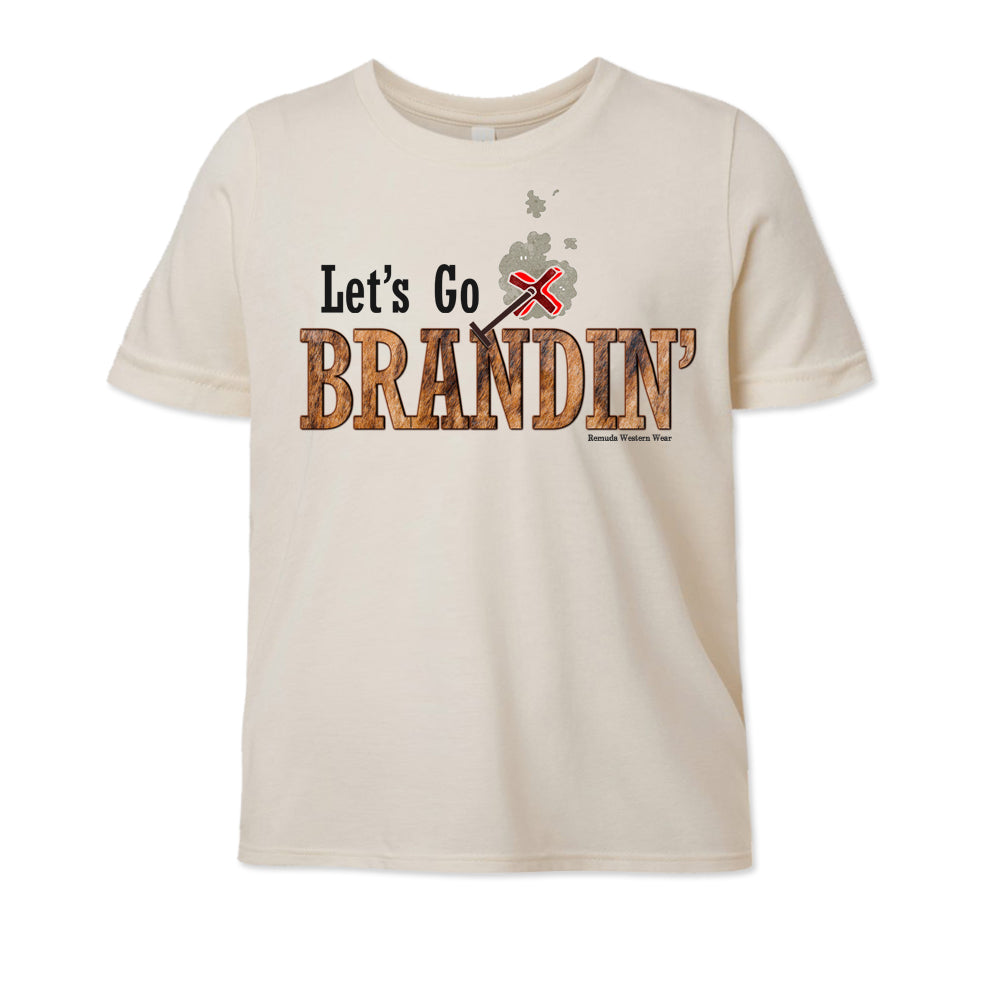 A stylish western-themed solid natural colored youth t-shirt featuring the phrase 'Let's Go Brandin'' prominently printed in bold, weathered letters across the chest. Above the shirt is is an illustration of a branding iron, evoking a rustic cowboy aesthetic. Kids Western wear, Ranch wear and Rodeo wear.