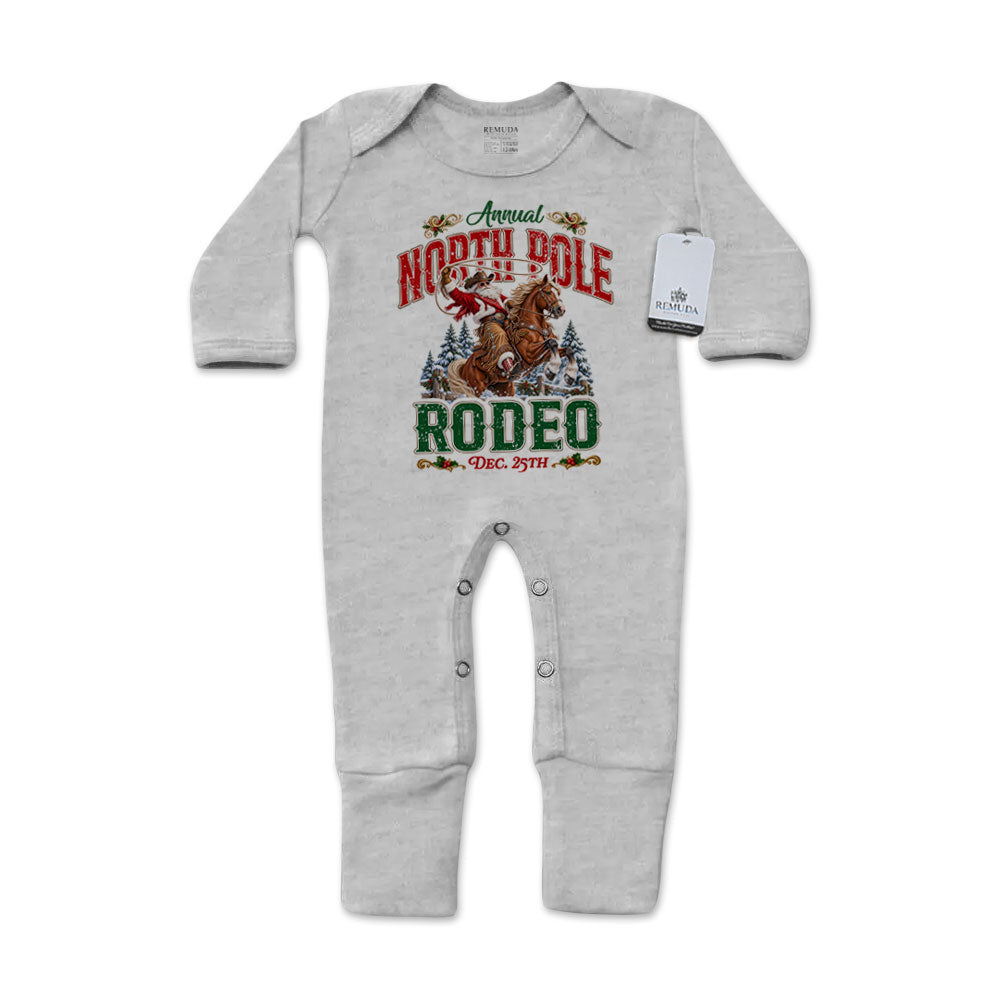 Heather Gray-colored infant one-piece footed pajamas featuring a festive North Pole Rodeo Christmas graphic with cowboy Santa riding a rearing horse, red and green lettering, long sleeves, and snap closures.