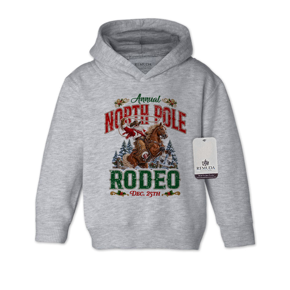 Heather Gray toddler pullover hoodie featuring a festive North Pole Rodeo Christmas design with Cowboy Santa riding a rearing horse, snowy pine trees, vintage red and green lettering, December 25th details, and ribbed cuffs and hem.