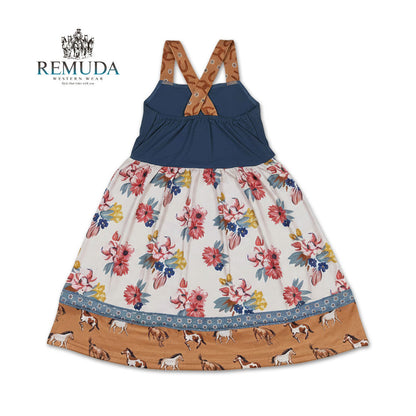 Back view of girls western "Petals & Ponies" floral dress showing crossed back straps, flowing wildflower skirt, and horse print hem.