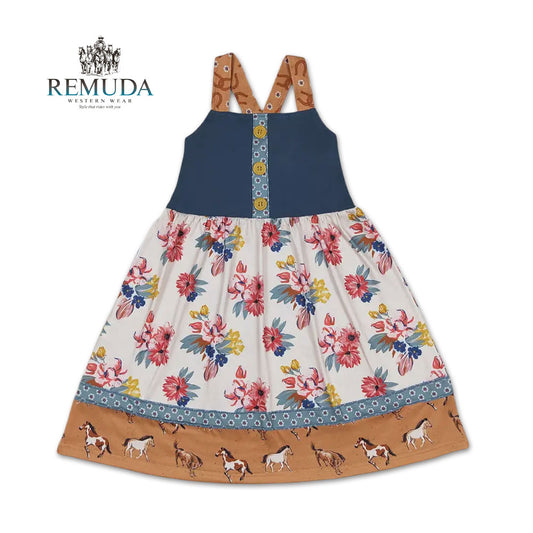 Girls western "Petals & Ponies" floral dress with a navy bodice with yellow buttons, soft wildflower skirt, running horse hem, and crossed back straps.