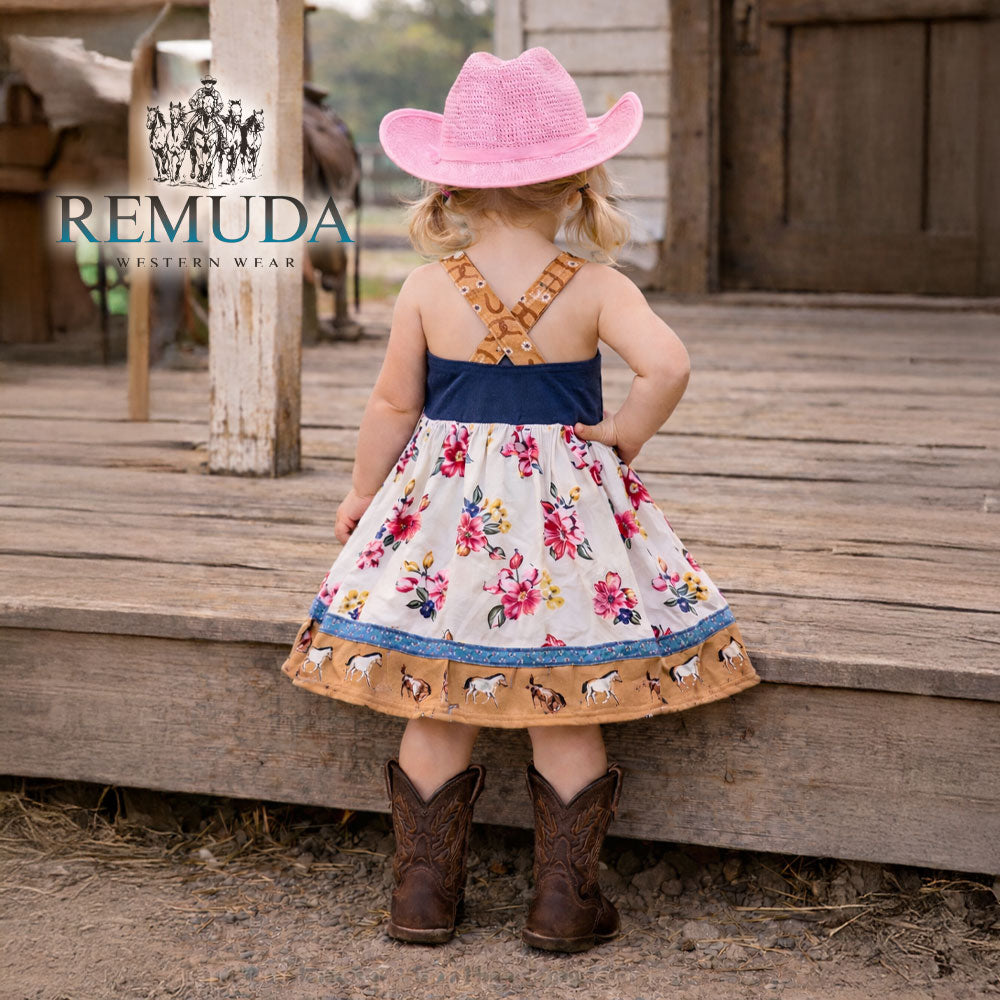 Back view of girls western "Petals & Ponies" floral dress showing crossed back straps, flowing wildflower skirt, and horse print hem.