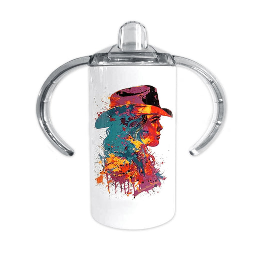 A children's western cowgirl style sippy cup tumbler entitled "The Neon Cowgirl", featuring a rich and vibrant paint splatter style profile image of a cowgirl in neon colors. 
