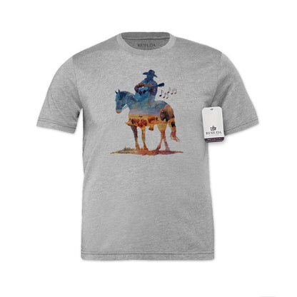 Watercolor-style illustration on a western heather gray colored t-shirt showing a cowboy on horseback playing a guitar, with a soft, artistic western aesthetic titled “Where The Buffalo Roam.”