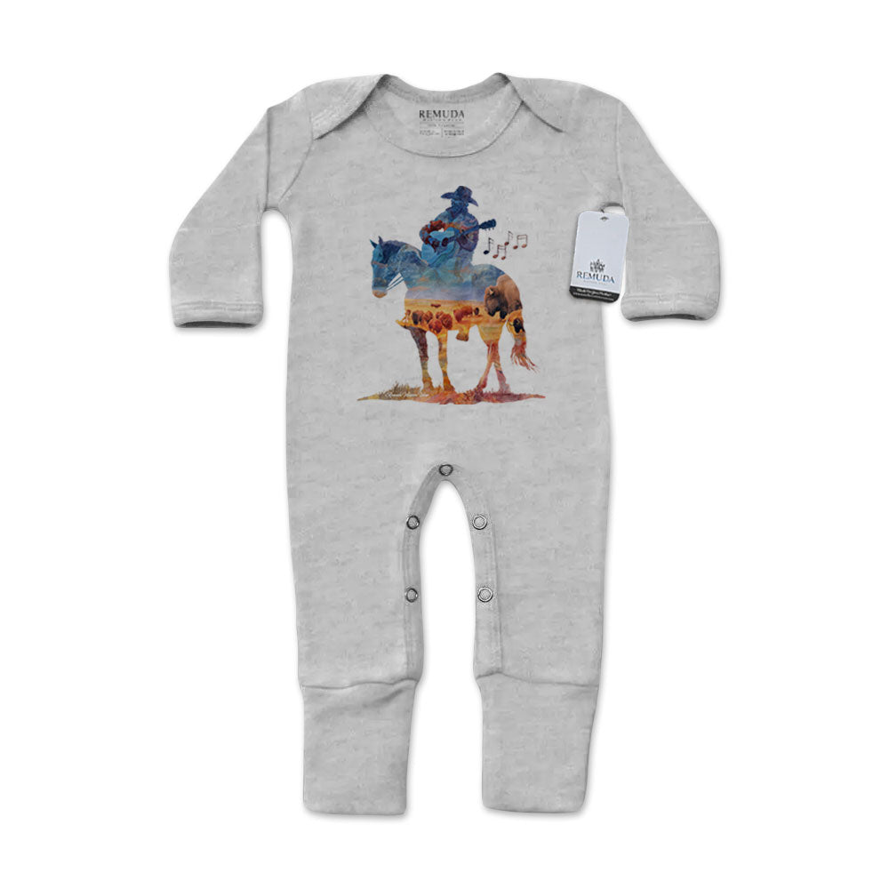 Infant one-piece footed gray colored sleepwear with built-in mittens featuring a watercolor-style design of a cowboy on horseback playing a guitar, titled “Where The Buffalo Roam,” in a soft, artistic western theme.