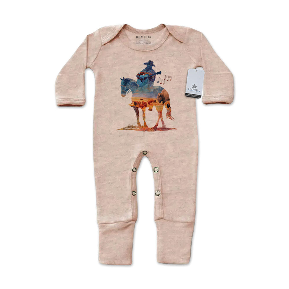 Infant one-piece footed sandstone colored sleepwear with built-in mittens featuring a watercolor-style design of a cowboy on horseback playing a guitar, titled “Where The Buffalo Roam,” in a soft, artistic western theme.