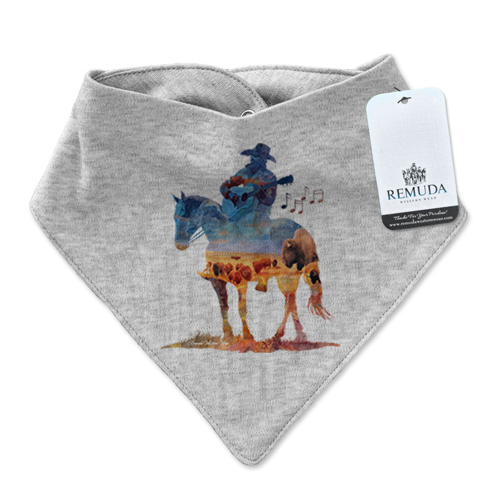Infant/toddler gray colored bandana bib with a watercolor-style illustration of a cowboy on horseback playing a guitar, overlaid with a herd of roaming buffalo, creating a soft, artistic western design.
