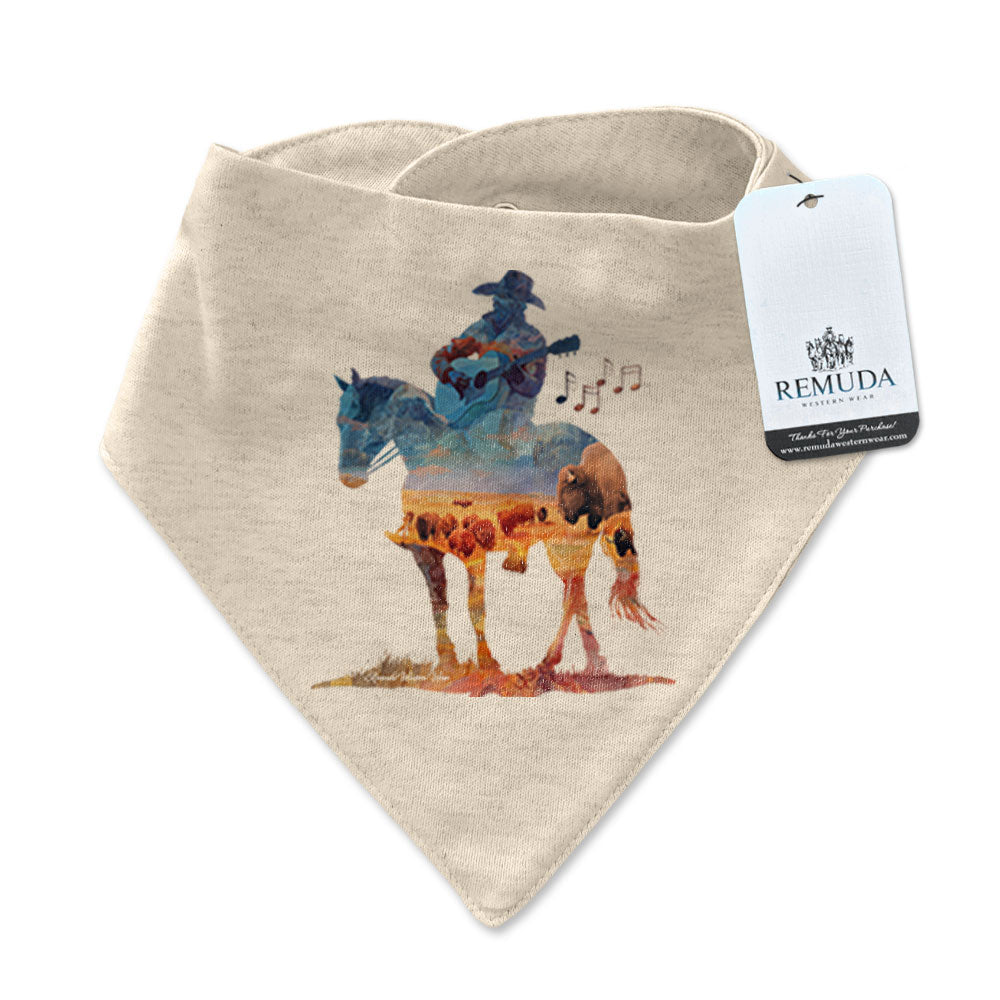 Infant/toddler oatmeal colored bandana bib with a watercolor-style illustration of a cowboy on horseback playing a guitar, overlaid with a herd of roaming buffalo, creating a soft, artistic western design.