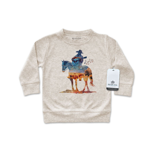 Watercolor-style illustration on an oatmeal colored infant long sleeve pullover showing a cowboy on horseback playing a guitar, titled “Where The Buffalo Roam,” in a soft, artistic western design.