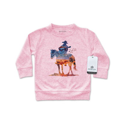 Watercolor-style illustration on an pink colored infant long sleeve pullover showing a cowboy on horseback playing a guitar, titled “Where The Buffalo Roam,” in a soft, artistic western design.