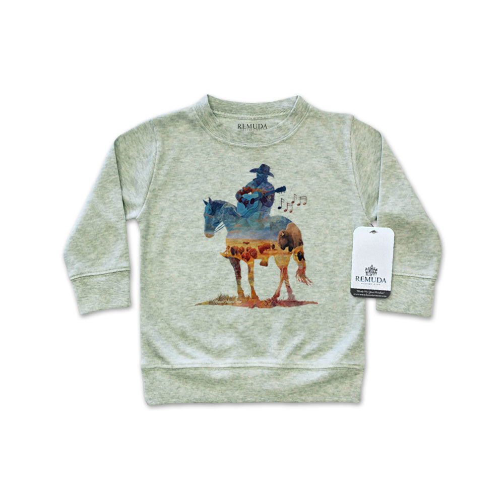 Watercolor-style illustration on an sage heather green colored infant long sleeve pullover showing a cowboy on horseback playing a guitar, titled “Where The Buffalo Roam,” in a soft, artistic western design.