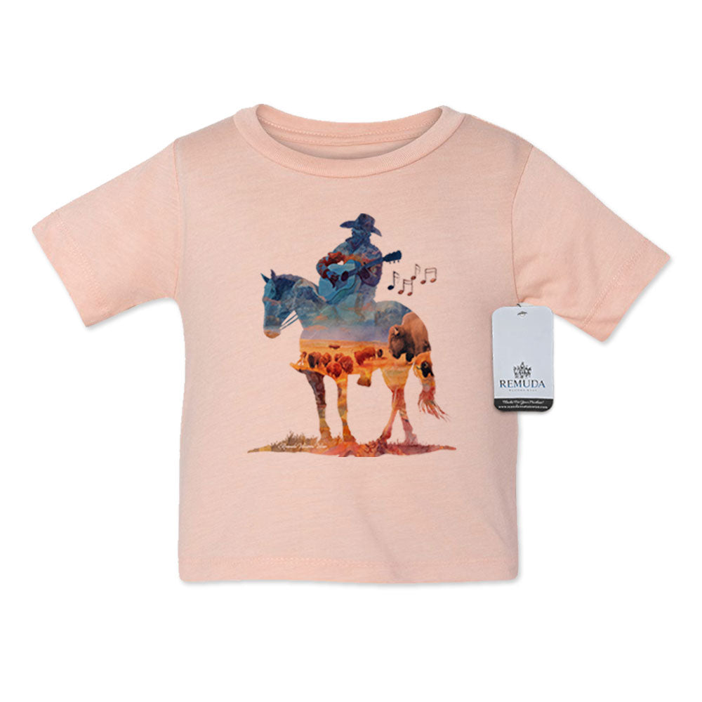 Watercolor-style western illustration on an infant Desert rose color t-shirt featuring a cowboy on horseback playing a guitar, with a soft, artistic “Where The Buffalo Roam” overlay design.
