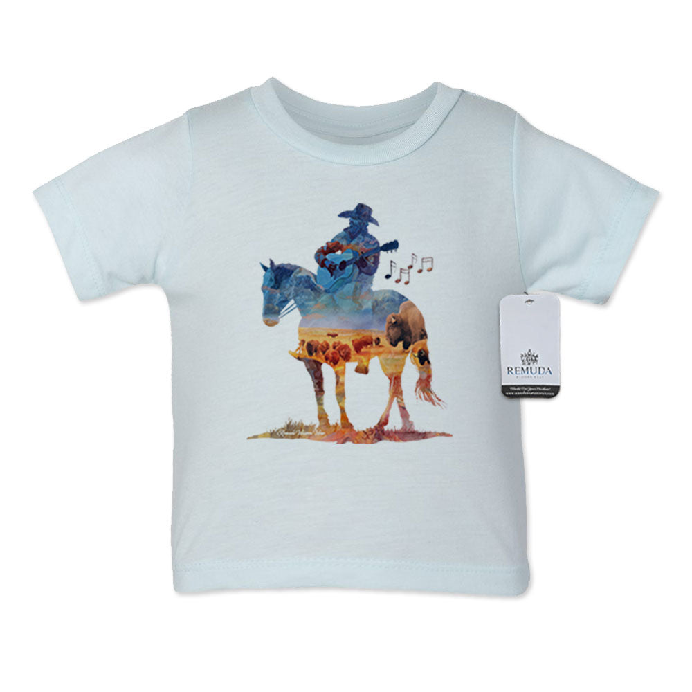 Watercolor-style western illustration on an infant light blue color t-shirt featuring a cowboy on horseback playing a guitar, with a soft, artistic “Where The Buffalo Roam” overlay design.