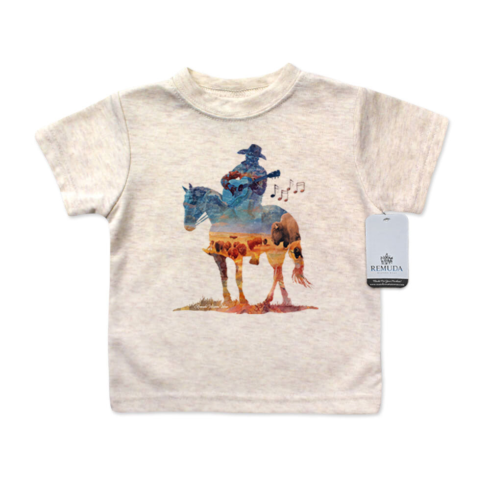 Watercolor-style western illustration on an infant oatmeal color t-shirt featuring a cowboy on horseback playing a guitar, with a soft, artistic “Where The Buffalo Roam” overlay design.