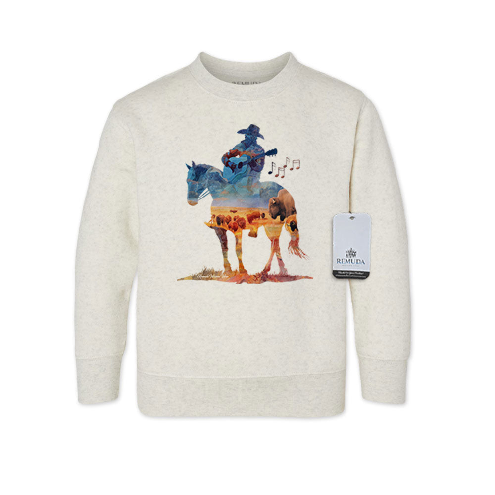 Watercolor-style illustration on an oatmeal toddler sweatshirt showing a cowboy on horseback playing a guitar, with a playful western theme titled “Where The Buffalo Roam.”
