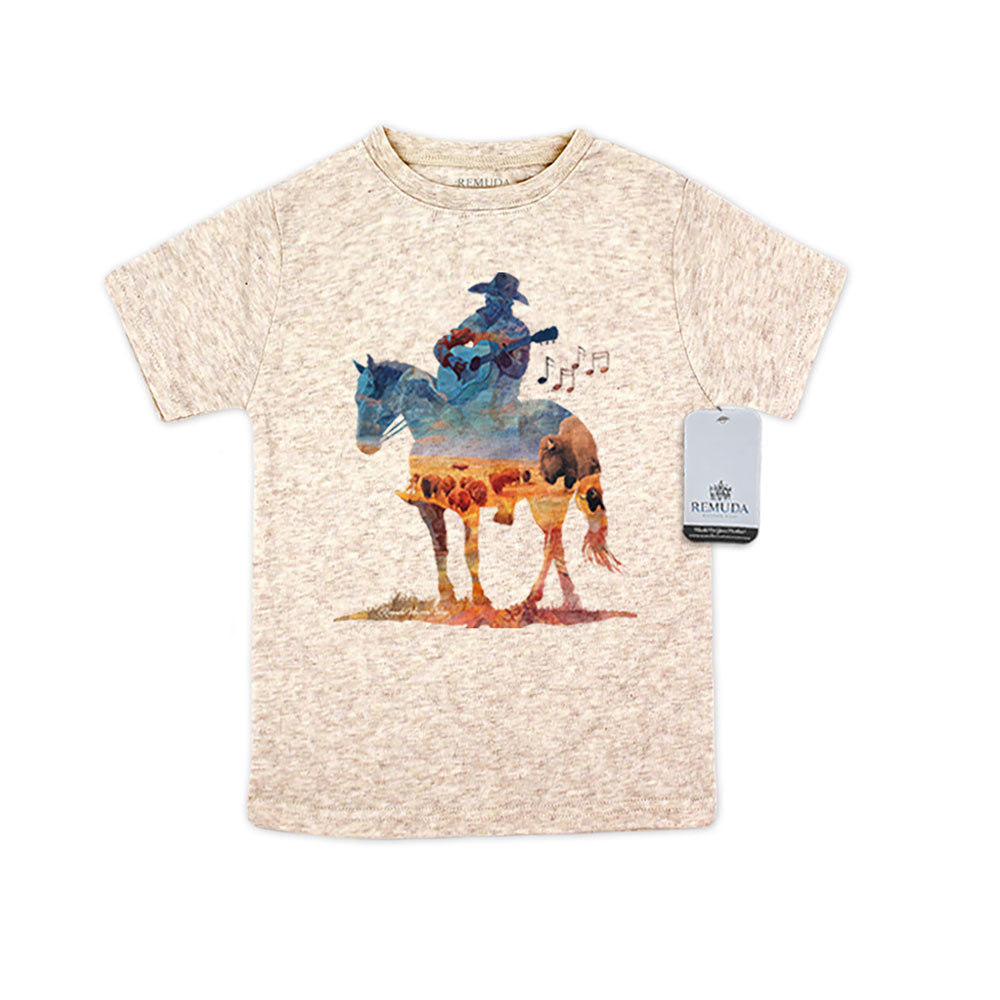 Watercolor-style illustration on an oatmeal toddler t-shirt showing a cowboy on horseback playing a guitar, titled “Where The Buffalo Roam,” with a playful western theme.